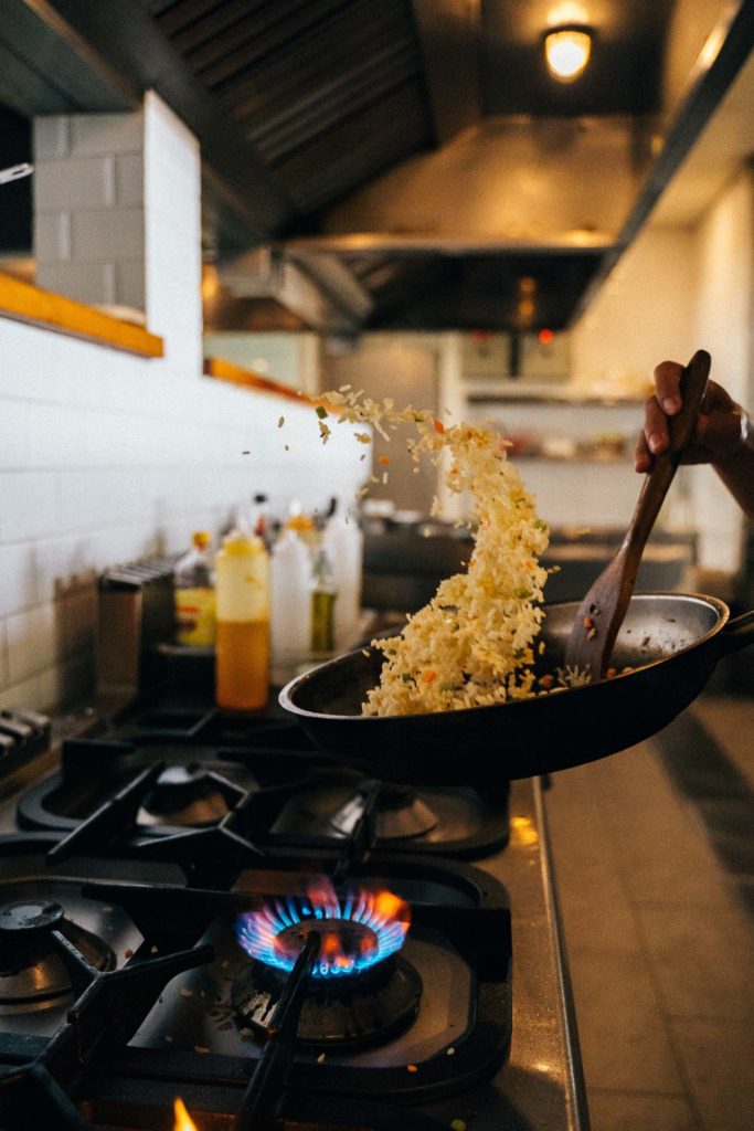 tossing food with a frying skillet